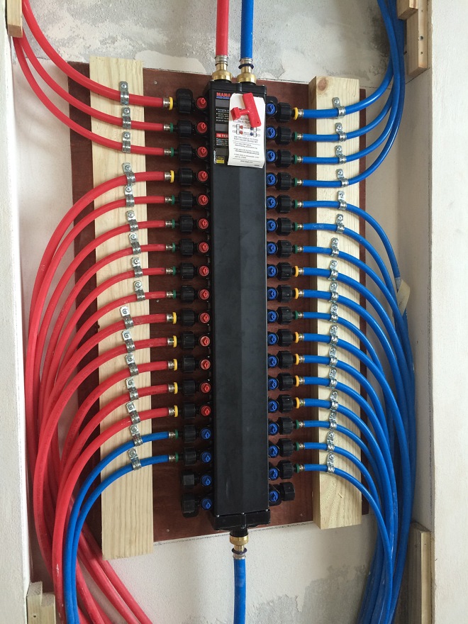 PEX distribution manifold for hot and cold water lines.